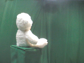 45 Degrees _ Picture 9 _ White Teddy Bear Wearing Gold Ribbon.png